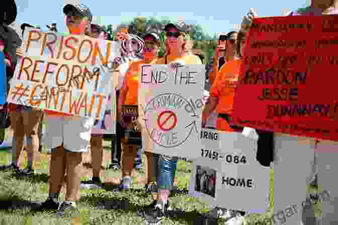 A Group Of People Holding Signs Advocating For Justice Reform The Business Of American Injustice